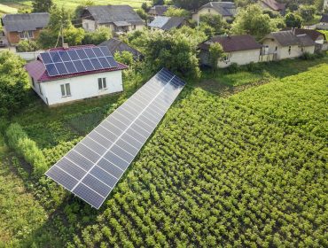 Aerial view of a house with blue solar panels for clean energy. Aerial view of a house with blue solar panels for clean energy.